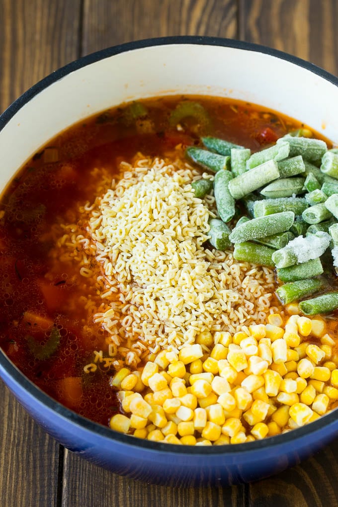 Alphabet Soup Recipe | Hamburger Soup | Beef and Vegetable Soup #soup #hamburger #noodles #dinner #sadud #carrots A pot with noodles, broth, frozen corn and frozen green beans.