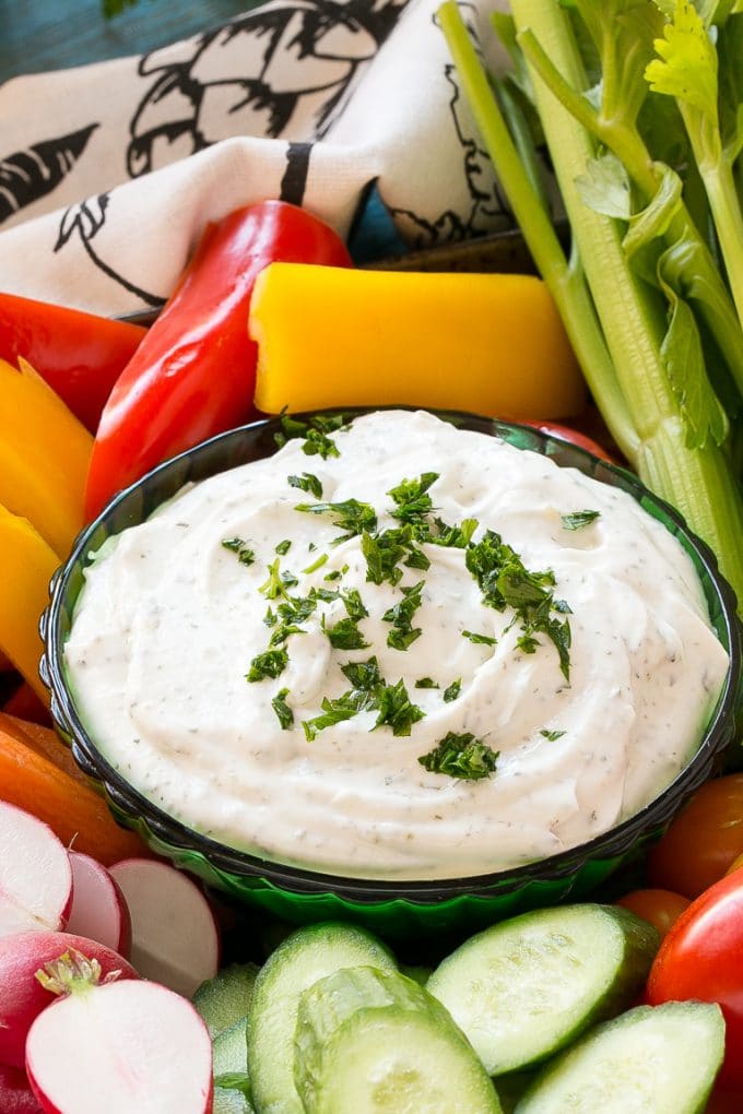 Homemade Ranch Dip Recipe | Homemade Ranch Powder | Homemade Ranch Dressing | Best Ranch Dip #ranch #dip #appetizer #snack #sadud A bowl of dip topped with chopped parsley and surrounded by vegetables.