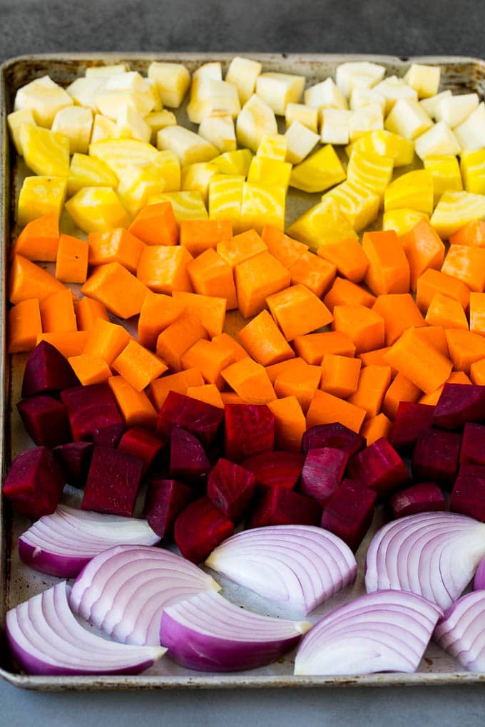 Roasted Root Vegetables Recipe | Roasted Sweet Potatoes | Roasted Beets | Roasted Carrots #carrots #beets #vegetables #sweetpotatoes #fall #parsnips #sidedish #sadud #cleaneating #healthy Onions, carrots, beets, parsnips and sweet potatoes on a sheet pan.