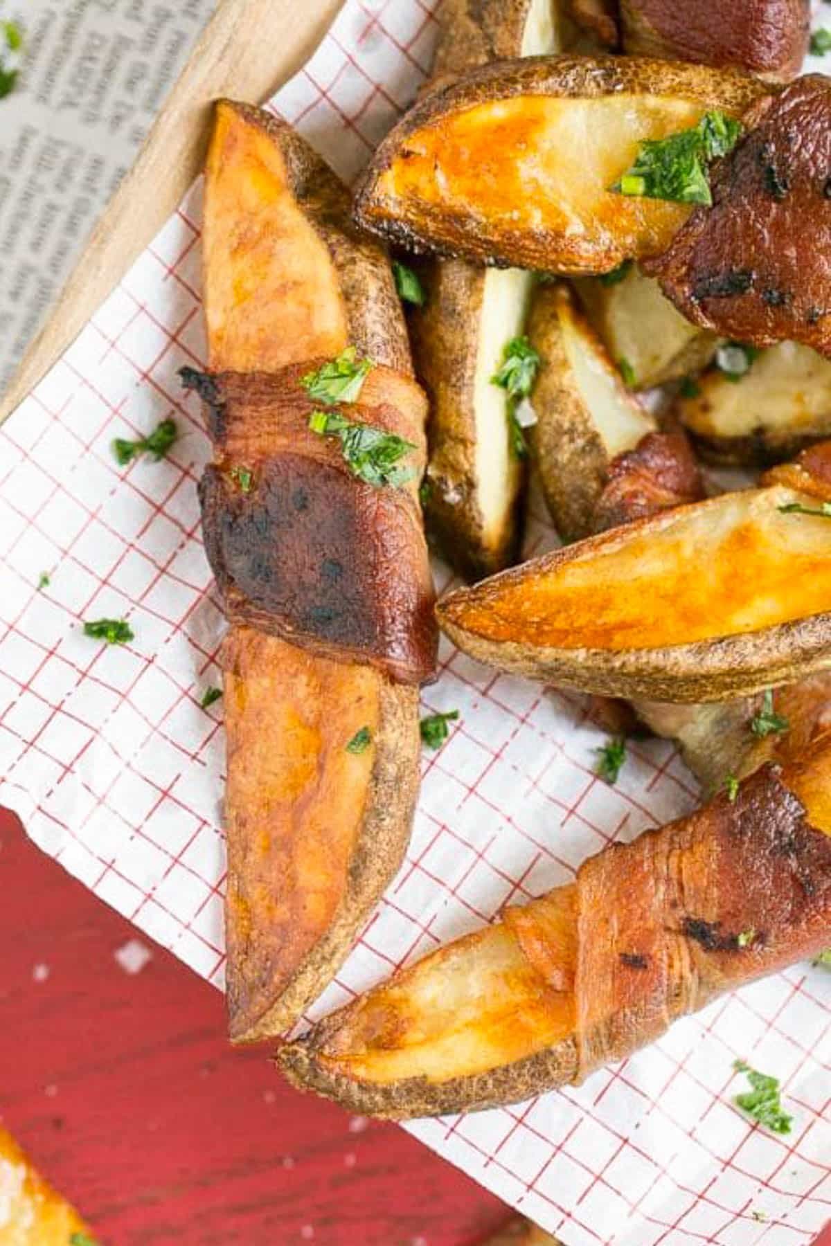 Bacon Wrapped Potato Wedges Recipe | Best Potato Wedges | Bacon Wrapped French Fries | Bacon Potato Wedges #bacon #potato #fries #dinner #sadud Bacon wrapped potatoes on a serving tray, topped with parsley.