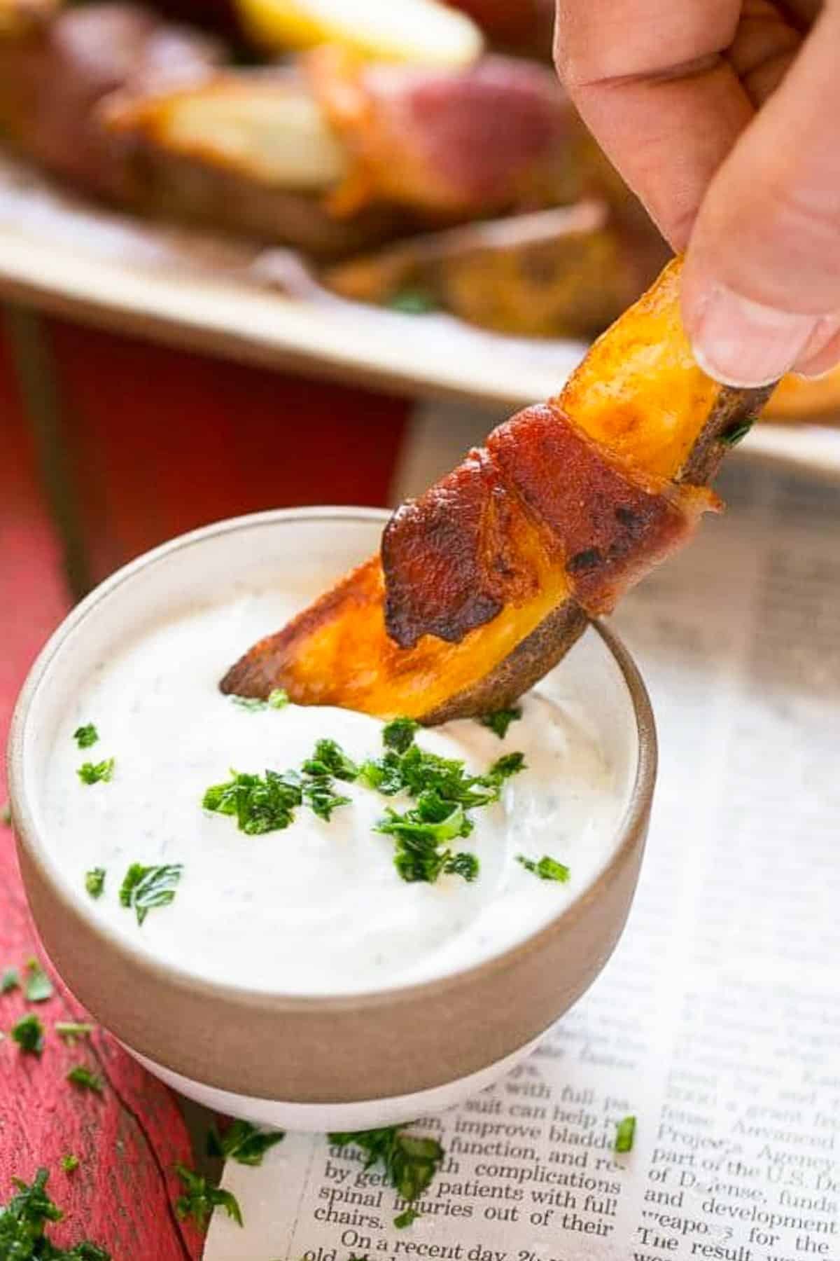 Bacon Wrapped Potato Wedges Recipe | Best Potato Wedges | Bacon Wrapped French Fries | Bacon Potato Wedges #bacon #potato #fries #dinner #sadud A hand putting bacon wrapped potatoes into ranch dip.