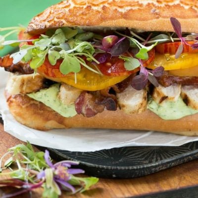 This updated club sandwich includes lemon herb grilled chicken, homemade avocado ranch spread, plenty of bacon and lots of summer tomatoes.
