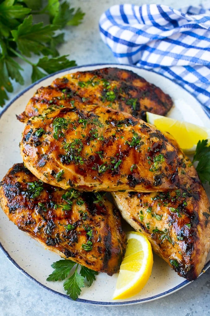 Grilled Chicken Breast Recipe | Marinated Chicken Breast | Chicken Marinade #chicken #grilling #marinade #summer #dinner #sadud A platter of grilled chicken breast served with parsley and lemon.