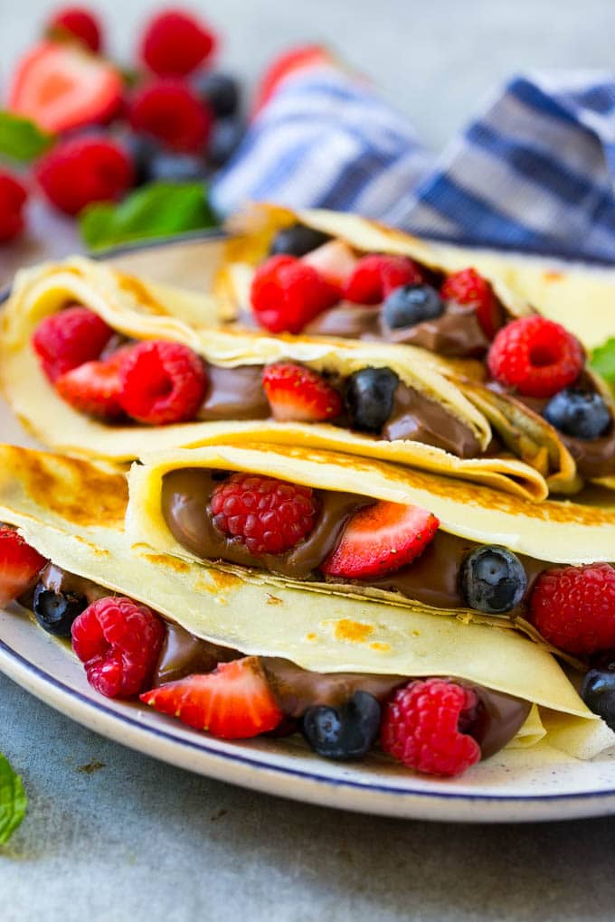 Nutella Crepes Recipe | Easy Crepes Recipe | Blender Crepes | Berry Crepes #crepes #nutella #nutellacrepes #blendercrepes #breakfast #sadud A stack of crepes that are stuffed full of chocolate Nutella spread and fresh berries.
