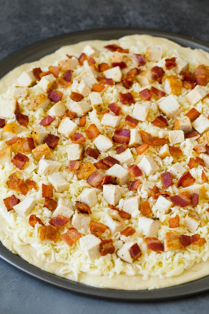 Chicken Alfredo Pizza Recipe #pizza #chicken #bacon #dinner #sadud A crust topped with sauce, shredded cheese and meat.