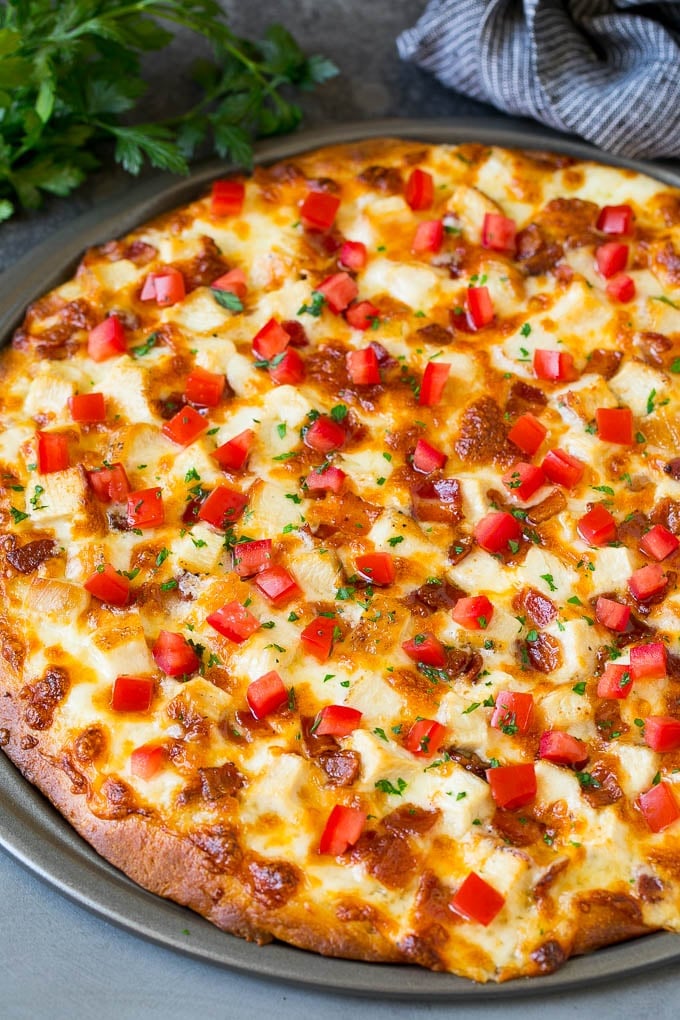 Chicken Alfredo Pizza Recipe #pizza #chicken #bacon #dinner #sadud A pizza topped with chicken, bacon, tomatoes and parsley.
