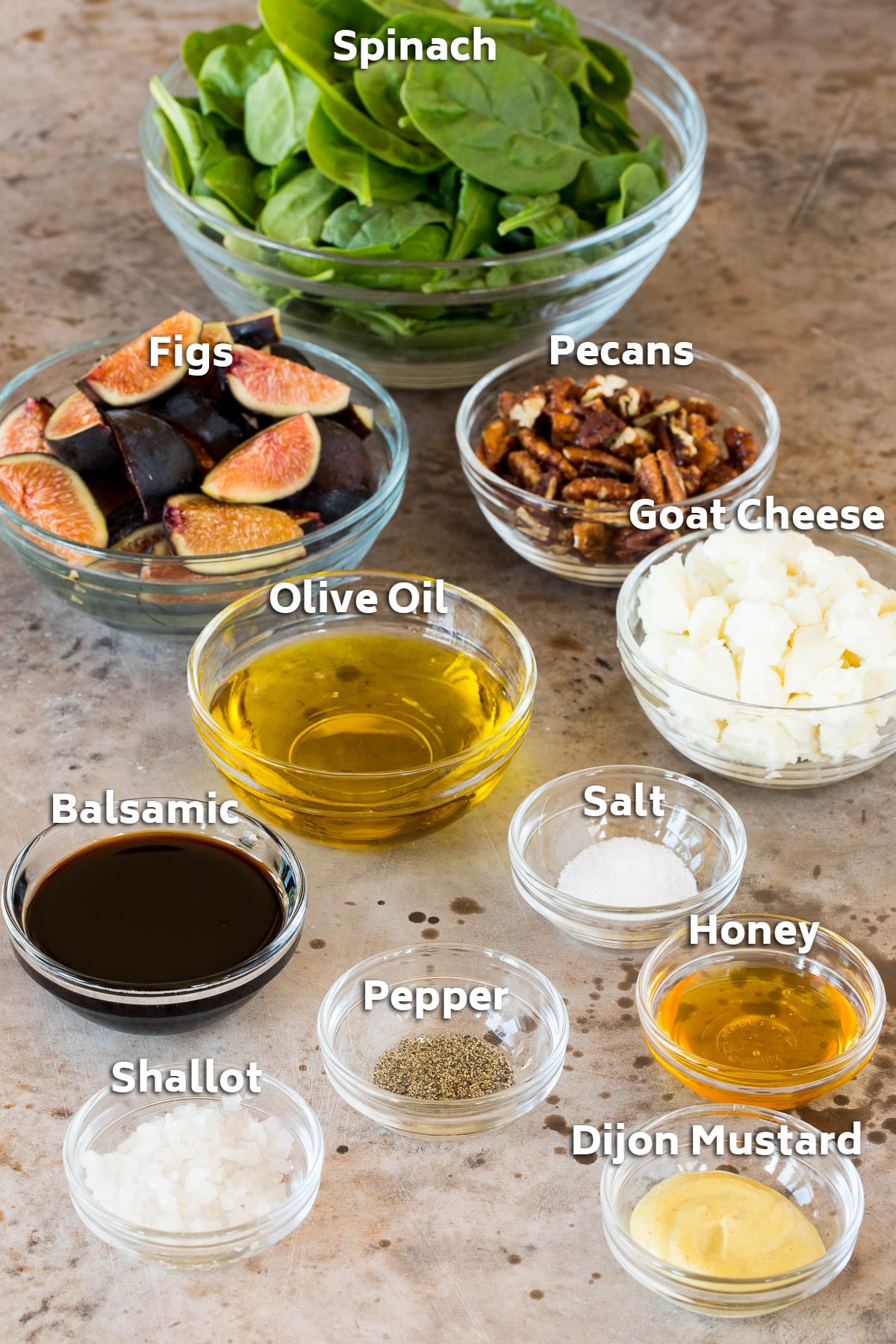 Bowls of ingredients including figs, cheese, pecans, olive oil and seasonings.
