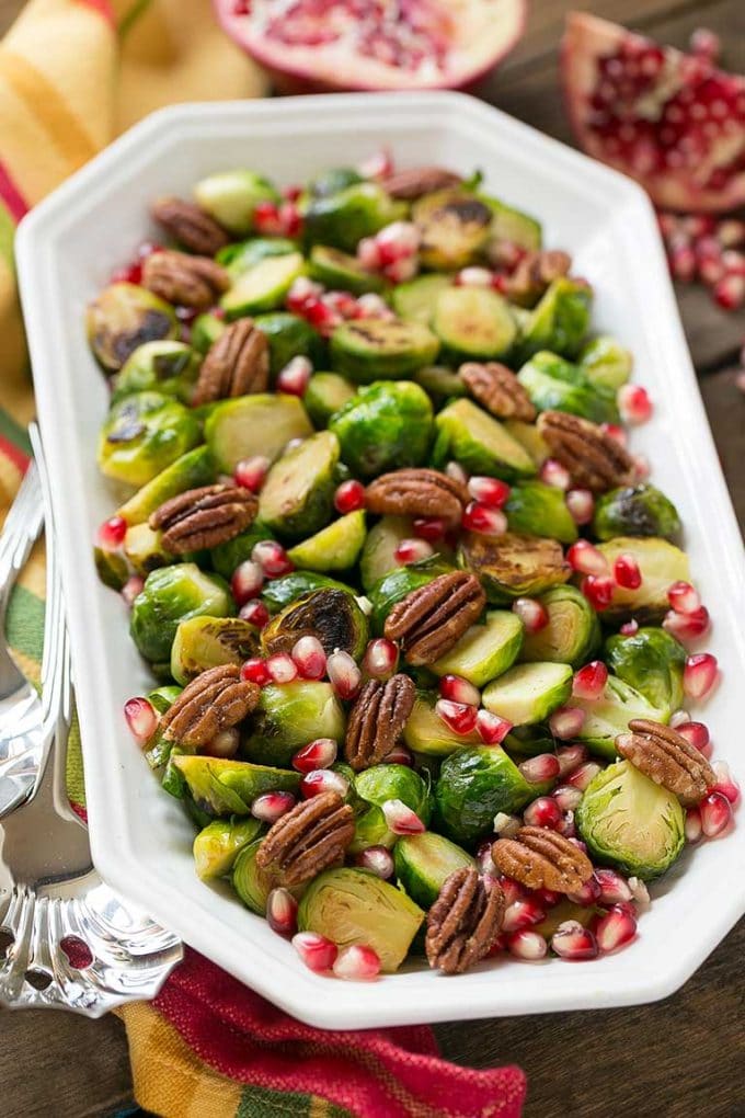 Pomegranate Brussels sprouts with pecans is a serving dish.