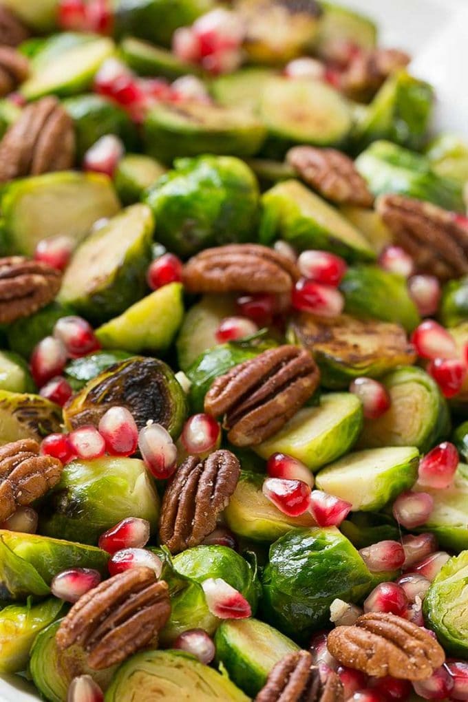 Roasted Brussels sprouts with pomegranate seeds and halved pecans.