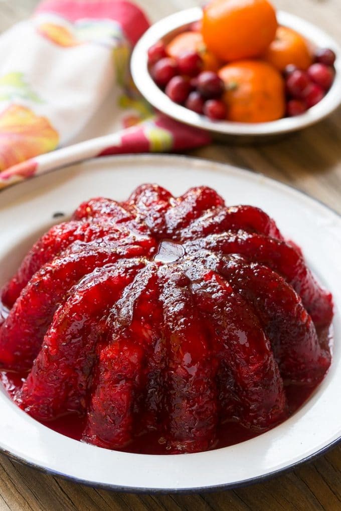 A red gelatin mold in a serving dish.