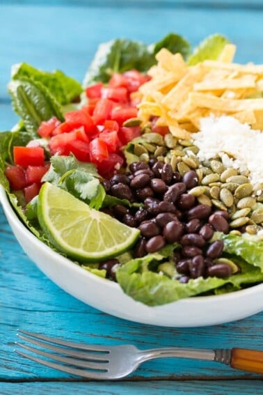 This recipe for mexican caesar salad is crisp romaine lettuce tossed in a creamy cilantro dressing, then finished off with a variety of fun toppings. It's caesar salad in a whole new way that might be even better than the original!
