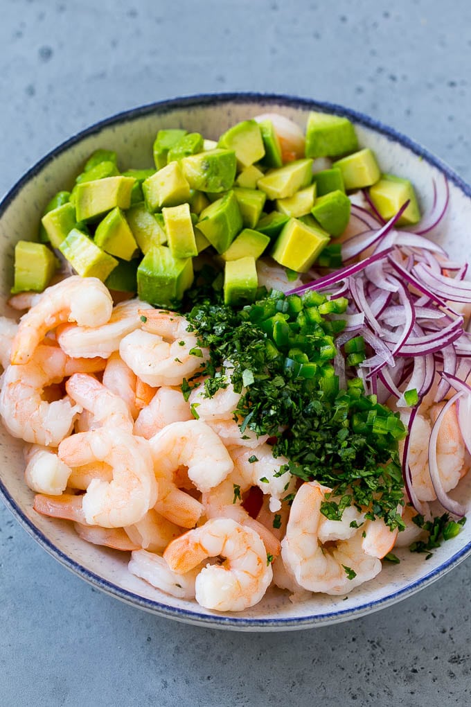 Mexican Shrimp Cocktail Recipe | Coctel de Camarones | Shrimp Cocktail | Mexican Shrimp #shrimp #appetizer #avocado #mexican #sadud Shrimp, red onion, avocado, jalapeno and cilantro in a serving bowl.