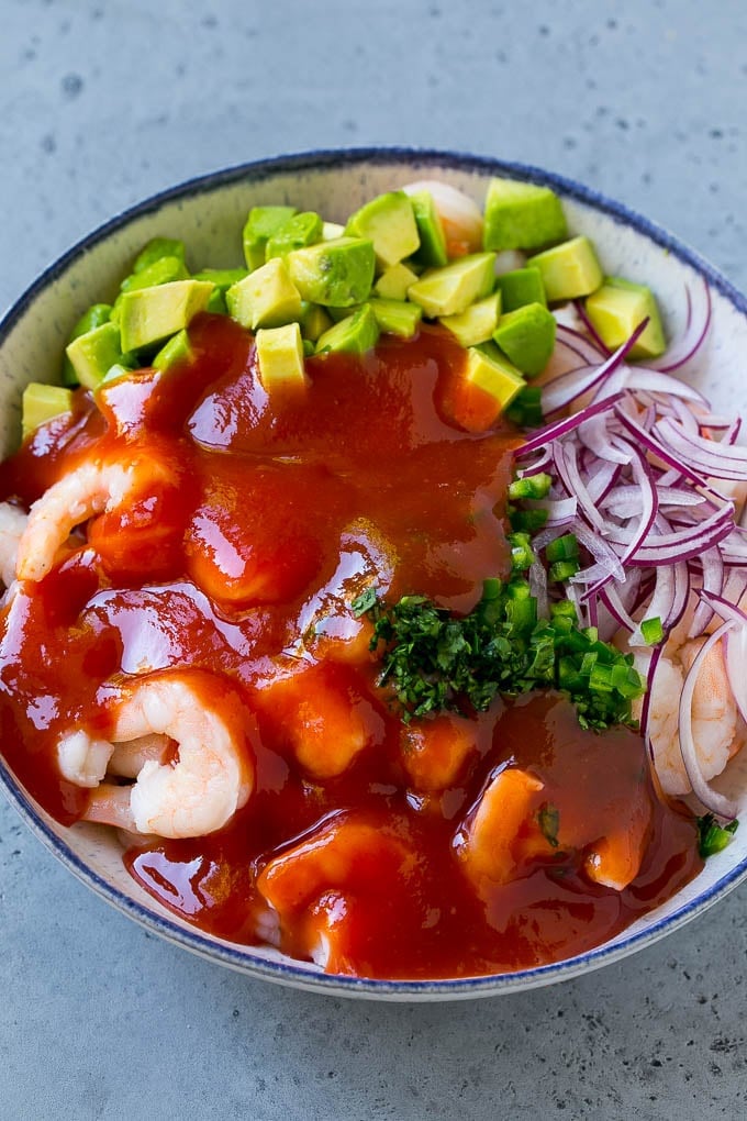 Mexican Shrimp Cocktail Recipe | Coctel de Camarones | Shrimp Cocktail | Mexican Shrimp #shrimp #appetizer #avocado #mexican #sadud Shrimp, avocado, red onion and cilantro topped with cocktail sauce.