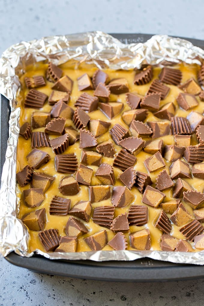 Chocolate Peanut Butter Fudge Recipe | Peanut Butter Cup Fudge | Easy Fudge Recipe #chocolate #peanutbutter #fudge #baking #dessert #sadud Layered peanut butter chocolate fudge in a square pan.