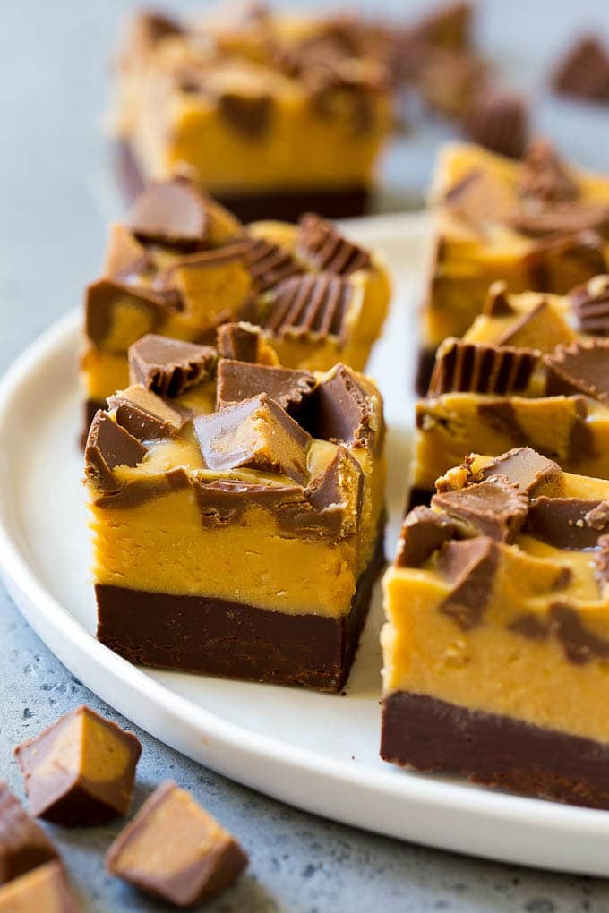 Chocolate Peanut Butter Fudge Recipe | Peanut Butter Cup Fudge | Easy Fudge Recipe #chocolate #peanutbutter #fudge #baking #dessert #sadud Squares of chocolate peanut butter fudge topped with peanut butter cups.