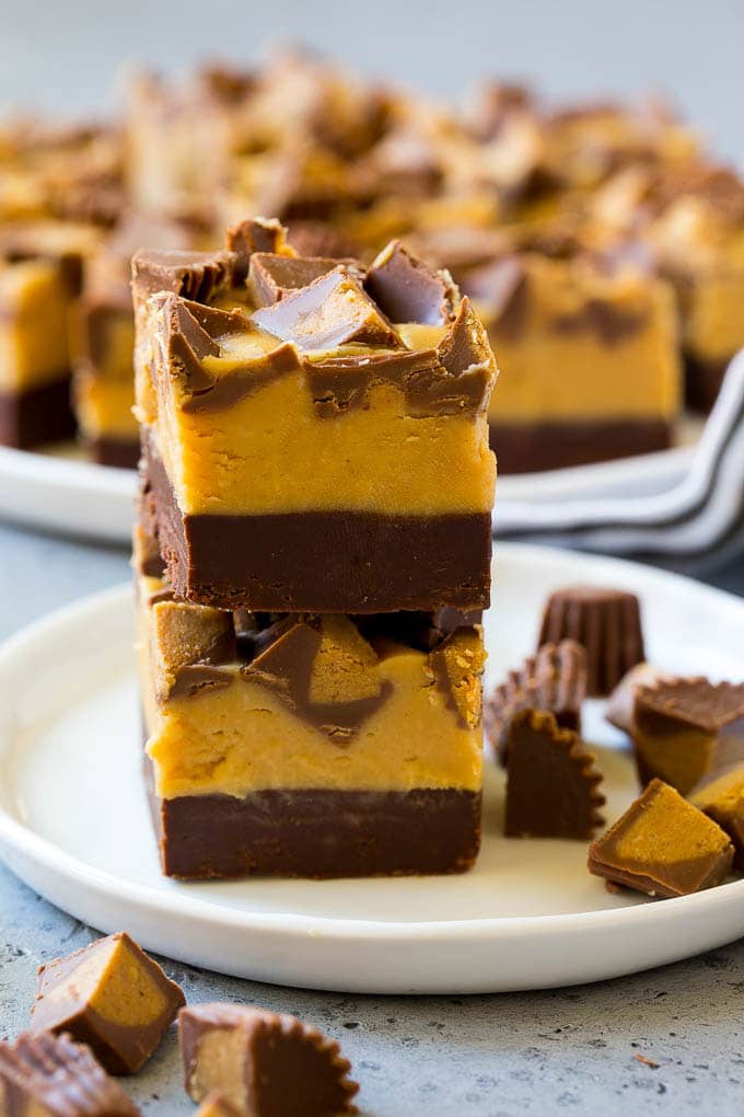 Chocolate Peanut Butter Fudge Recipe | Peanut Butter Cup Fudge | Easy Fudge Recipe #chocolate #peanutbutter #fudge #baking #dessert #sadud Stacked pieces of chocolate peanut butter fudge on a plate.