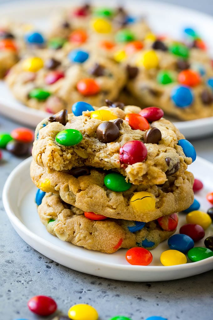 Monster Cookies Recipe | Oatmeal Cookies | Peanut Butter Cookies | M&M's Cookies #baking #cookies #dessert #peanutbutter #chocolate #sadud A stack of monster cookies with a bite taken out of one.