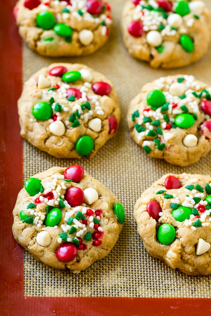 Christmas Monster Cookies Recipe | Oatmeal Cookies | Peanut Butter Cookies | M&M's Cookies #baking #cookies #dessert #peanutbutter #chocolate #sadud #christmas #sprinkles Baked Christmas cookies on a sheet pan.