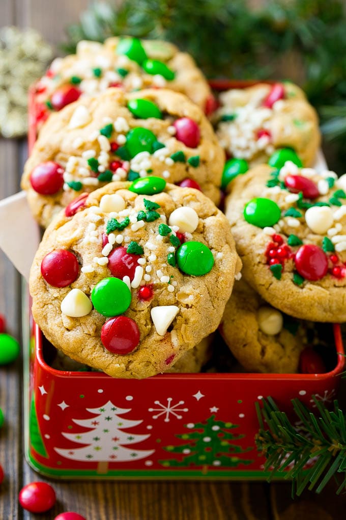 Christmas Monster Cookies Recipe | Oatmeal Cookies | Peanut Butter Cookies | M&M's Cookies #baking #cookies #dessert #peanutbutter #chocolate #sadud #christmas #sprinkles Christmas monster cookies in a gift tin.
