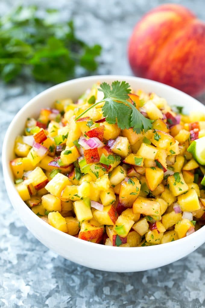 Peach Salsa | Fruit Salsa #peaches #salsa #dip #appetizer #sadud Peach salsa in a bowl made with red onion, jalapeno and cilantro.
