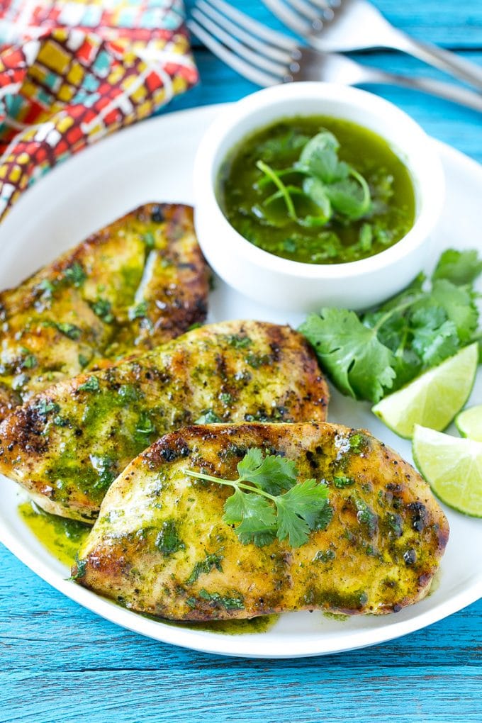 Cilantro Lime Chicken | Grilled Chicken #chicken #grilling #cilantro #lime #dinner #sadud Cilantro lime chicken topped with sauce and served with lime wedges.