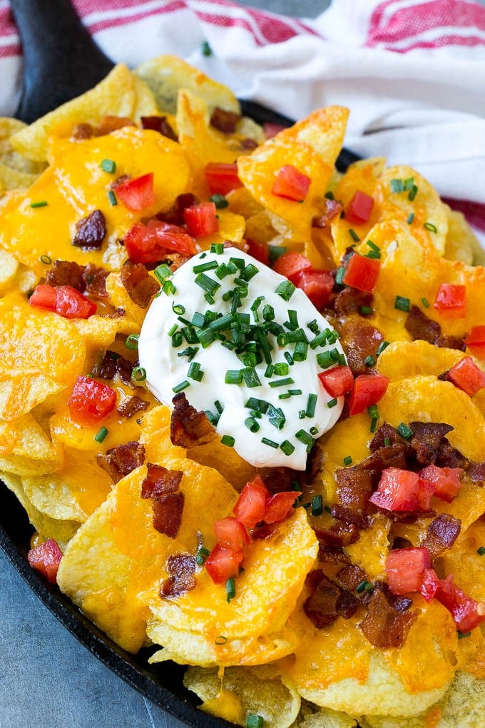 Irish Nachos Recipe | Potato Nachos | Potato Chip Recipe | Appetizer Recipe #nachos #potatoes #cheese #bacon #appetizer #sadud A skillet of Irish nachos topped with melted cheese, bacon, tomatoes and sour cream.
