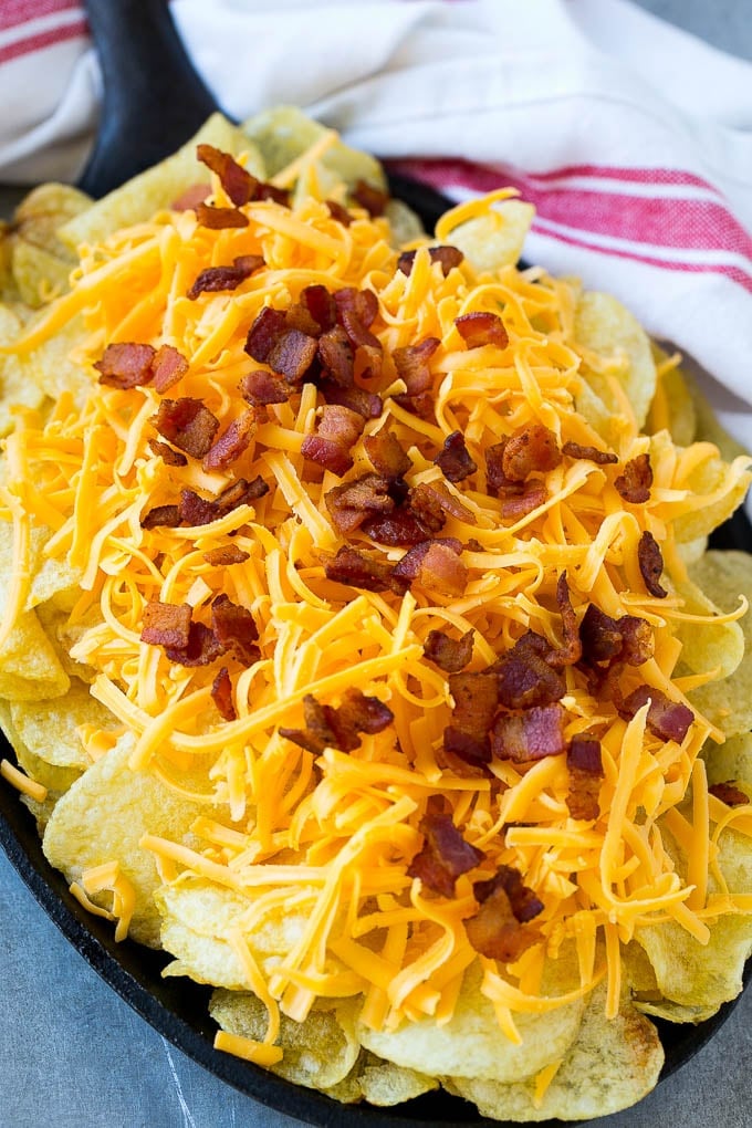 Irish Nachos Recipe | Potato Nachos | Potato Chip Recipe | Appetizer Recipe #nachos #potatoes #cheese #bacon #appetizer #sadud Kettle chips topped with shredded cheese and bacon.