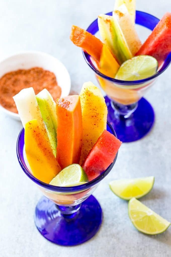 Mexican Fruit Cups | Fruit Cups | Mexican Fruit | Tropical Fruit #fruit #fruitcup #watermelon #pineapple #snack #healthy #sadud Spears of watermelon, cucumber, jicama, mango and pineapple in glasses.