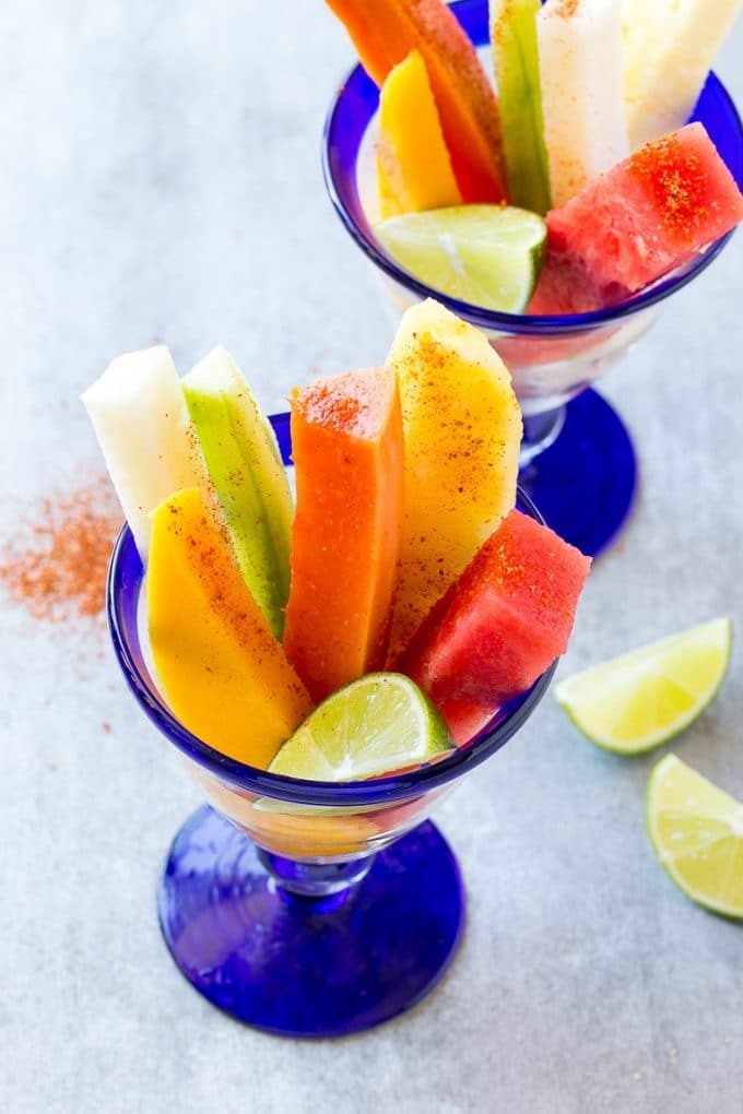 Mexican Fruit Cups | Fruit Cups | Mexican Fruit | Tropical Fruit #fruit #fruitcup #watermelon #pineapple #snack #healthy #sadud Mexican fruit cups with an assortment of fruit, topped with chili lime seasoning.