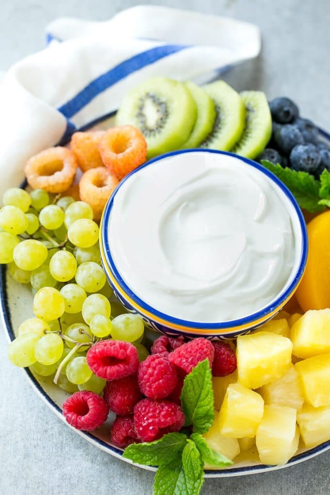 Cream Cheese Fruit Dip | Fruit Recipe | Fruit Dip #fruit #dip #creamcheese #snack #dessert #sadud A bowl of cream cheese fruit dip surrounded by colorful fruit.