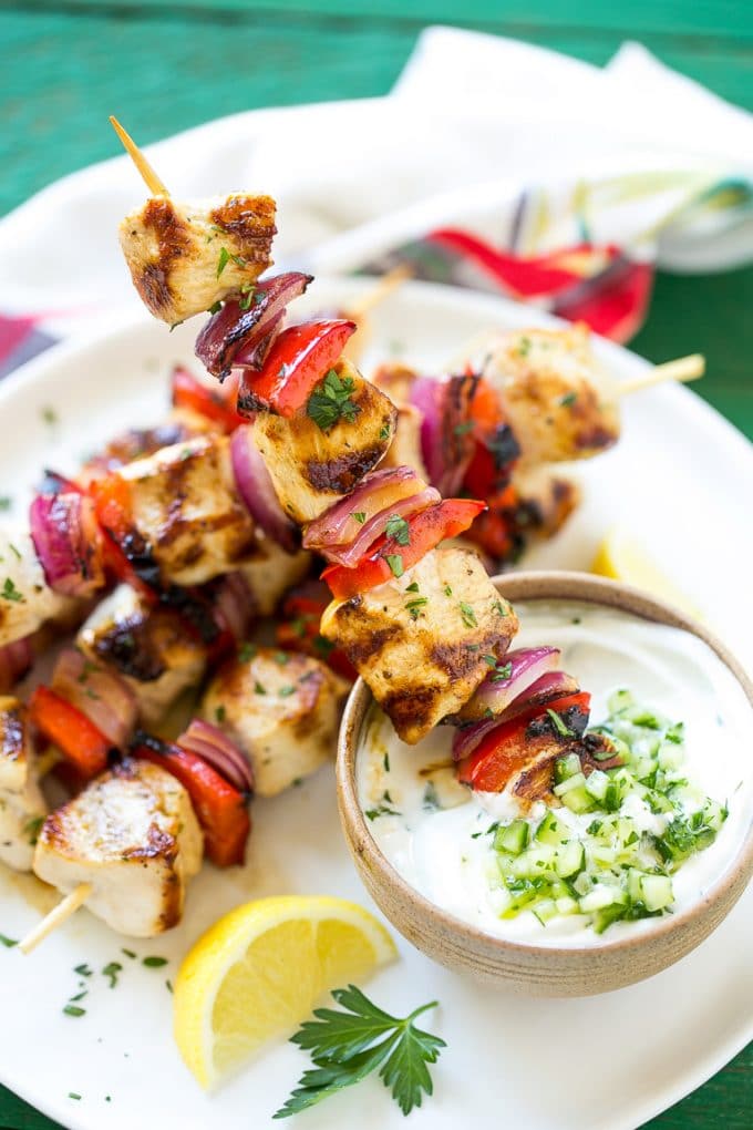 Greek Chicken Kabobs | Grilled Chicken Kabobs | Healthy Chicken Recipe | Greek Chicken #greekfood #chicken #grilling #grilledchicken #kabobs #dinner #sadud Skewered meat and veggies being dipped onto cucumber yogurt sauce.