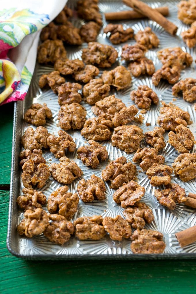 Candied Walnuts Recipe | Candied Nuts | Glazed Walnuts | Cinnamon Sugar Walnuts #walnuts #dessert #snack #sadud A sheet pan with a layer of glazed walnut halves.