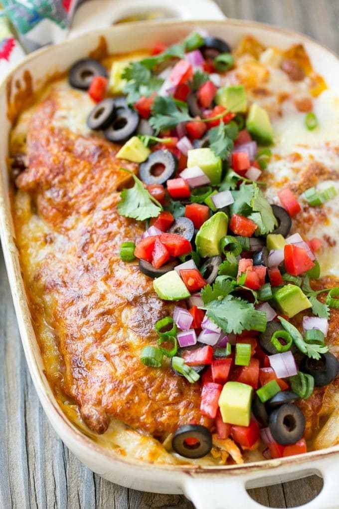 Chicken Enchilada Casserole Recipe | Chicken Enchiladas | Easy Casserole Recipe | Enchilada Casserole #chicken #casserole #enchiladas #cheese #beans #dinner #sadud Chicken enchilada casserole topped with avocado, tomatoes and olives.
