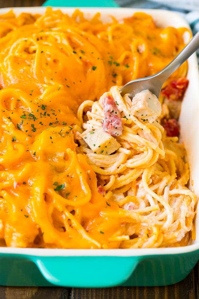 Chicken Spaghetti Recipe | Baked Spaghetti #pasta #spaghetti #chicken #cheese #casserole #dinner #sadud A fork serving up a portion of creamy chicken spaghetti.