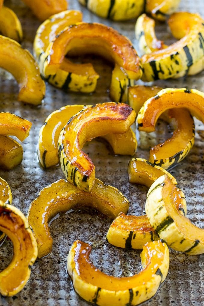 Brown Sugar Delicata Squash Recipe | Roasted Squash | Delicata Squash | Winter Squash Recipe #squash #wintersquash #brownsugar #sidedish #delicatasquash #dinner #sadud Roasted delicata squash on a sheet pan seasoned with brown sugar.