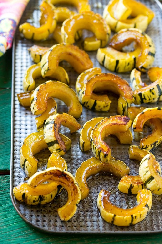 Brown Sugar Delicata Squash Recipe | Roasted Squash | Delicata Squash | Winter Squash Recipe #squash #wintersquash #brownsugar #sidedish #delicatasquash #dinner #sadud A sheet pan of a cooked winter squash recipe.