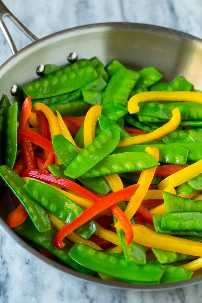 Teriyaki Shrimp Stir Fry Recipe | Shrimp Stir Fry | Healthy Stir Fry #shrimp #teriyaki #vegetables #stirfry #dinner #sadud Cooked snow peas and bell peppers in a skillet.