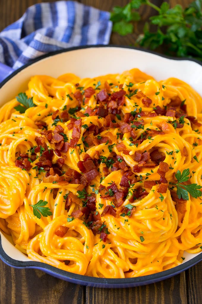 Butternut Squash Pasta Recipe #pasta #squash #bacon #fall #dinner #sadud Butternut squash pasta in a skillet topped with bacon and parsley.