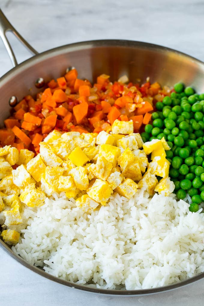 Veggie Fried Rice Recipe | Vegetarian Fried Rice #rice #friedrice #vegetarian #dinner #sadud #sidedish Vegetables, scrambled egg, rice and peas in a frying pan.