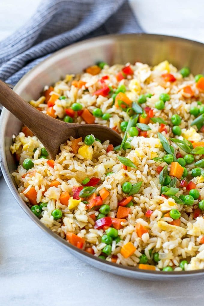 Veggie Fried Rice Recipe | Vegetarian Fried Rice | Easy Fried Rice Recipe | Chinese Food #rice #friedrice #veggie #vegetarian #sidedish #sadud Veggie fried rice in a skillet with a serving spoon.