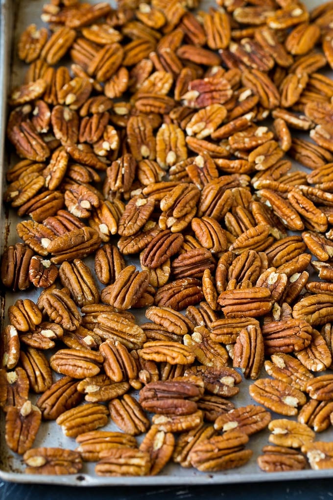 Candied Pecans Recipe | Glazed Pecans | Sugared Pecans #pecans #nuts #snack #dessert #sadud Pecan halves on a sheet pan.