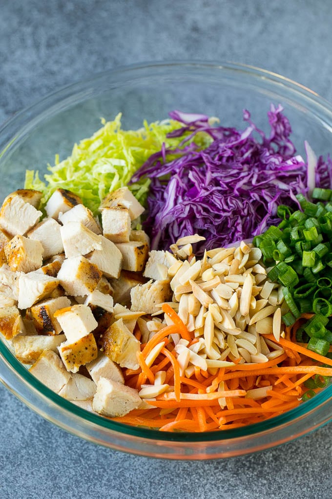 Chinese Chicken Salad Recipe | Asian Chicken Salad #salad #chicken #chickensalad #cabbage #lunch #dinner #sadud Cabbage, carrots, chicken, almonds and green onions in a bowl.