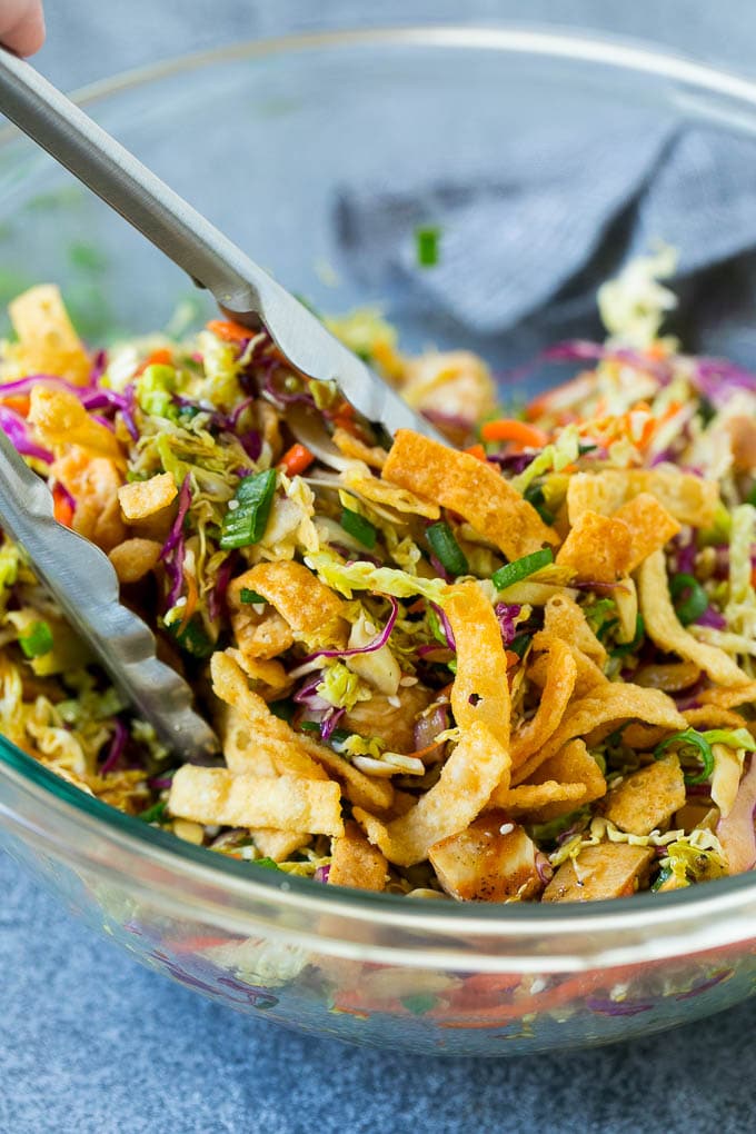 Chinese Chicken Salad Recipe | Asian Chicken Salad #salad #chicken #chickensalad #cabbage #lunch #dinner #sadud Tongs serving up a portion of Asian chicken salad.