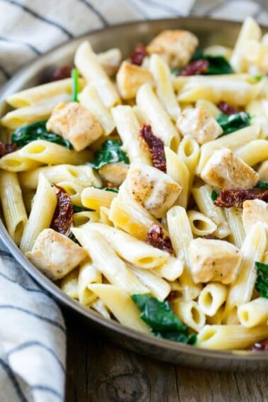 This recipe for sun dried tomato pasta is penne pasta with sauteed chicken and spinach, tossed in a creamy garlic sauce. An easy dinner that the whole family will love!