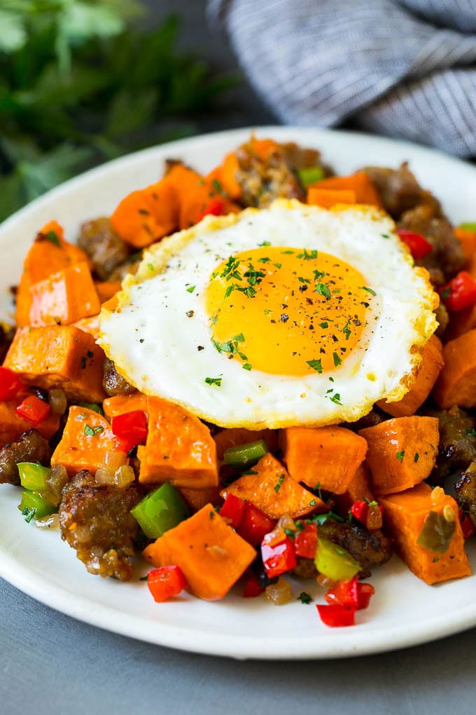 Sweet Potato Hash #sweetpotato #sausage #breakfast #brunch #sadud Sweet potato hash with sausage, topped with a fried egg.