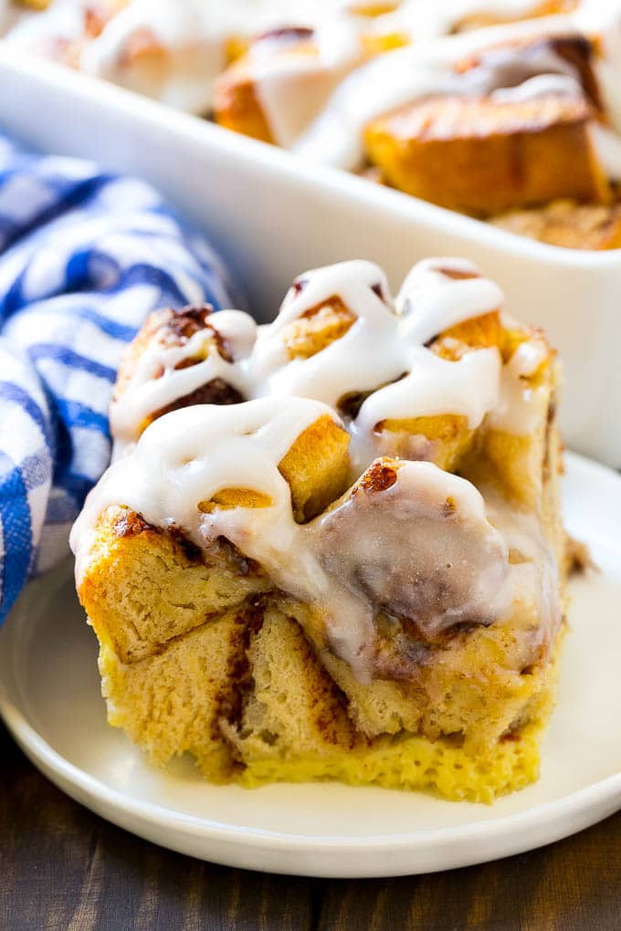 Cinnamon Roll French Toast Casserole | Cinnamon Roll French Toast Bake | Cinnamon Roll French Toast | Cinnamon French Toast #casserole #frenchtoast #cinnamonrolls #breakfast #sadud A slice of baked casserole topped with frosting.