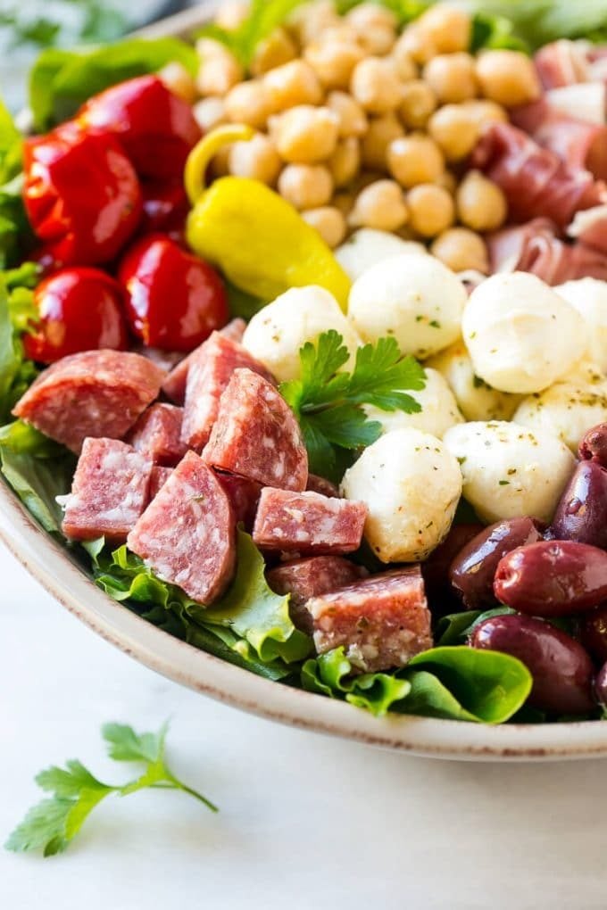 Antipasto Salad Recipe | Italian Salad | Main Course Salad | Antipasto Recipe #salad #salami #italianfood #dinner #lunch #sadud A bed of greens topped with antipasto salad including meats, cheeses, beans and vegetables.