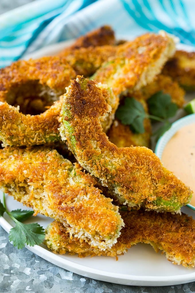 Avocado Fries Recipe | Fried Avocado | Avocado Fritters #avocado #appetizer #snack #sadud A plate of avocado fries garnished with fresh cilantro.