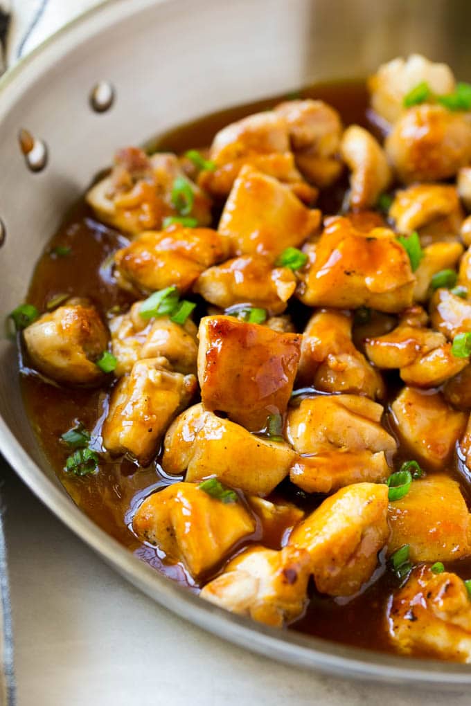 Bourbon Chicken | Sauteed Chicken | Chicken Stir Fry | Easy Chicken Recipe #chicken #dinner #sadud Bourbon chicken in a skillet coated in sauce and topped with green onions.