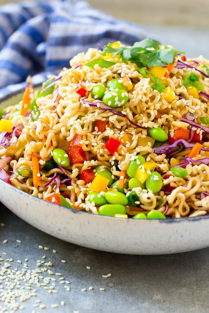 Asian Noodle Salad Recipe | Ramen Noodle Salad | Asian Salad #salad #noodles #edamame #vegetarian #sadud #lunch A mixture of ramen noodles, carrots, edamame, cabbage and peppers in a serving bowl.